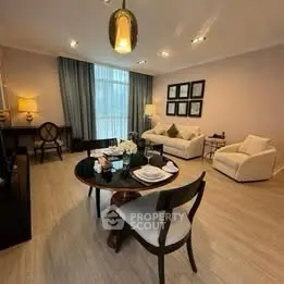 Elegant living room with modern decor and dining area, featuring cozy seating and stylish lighting.