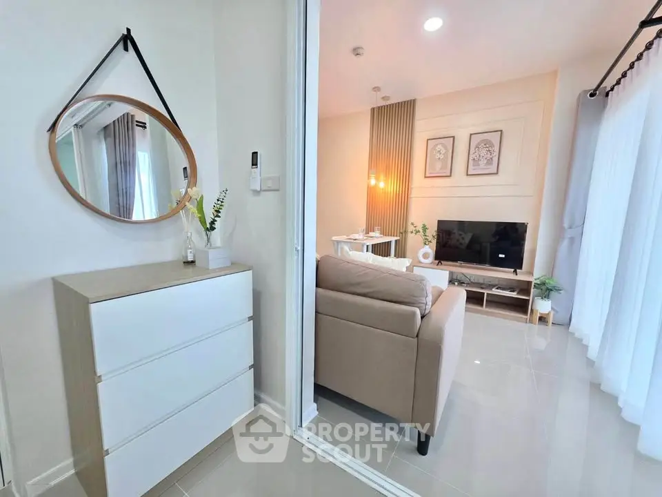 Modern living room with stylish decor and natural light, featuring a cozy sofa and elegant wall art.
