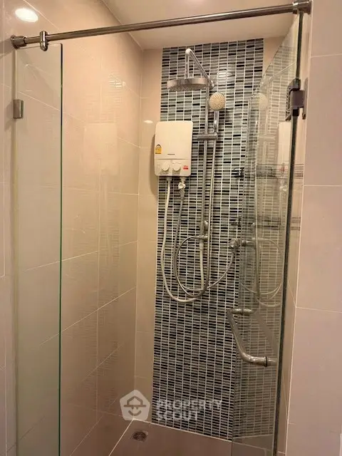 Modern bathroom with glass shower enclosure and stylish tile design