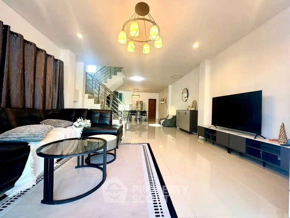 Spacious modern living room with elegant lighting and sleek furniture