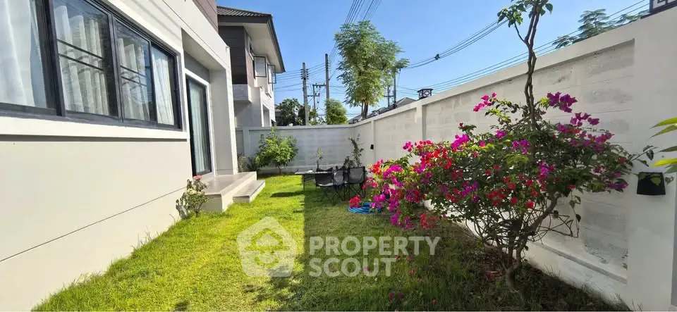 Charming garden area with vibrant flowers and lush greenery in a modern residential property.