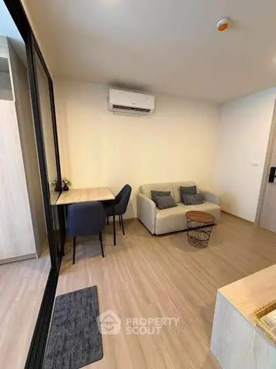 Modern living room with cozy sofa and dining area in stylish apartment.