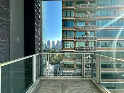 Modern balcony with glass railing offering stunning city skyline view