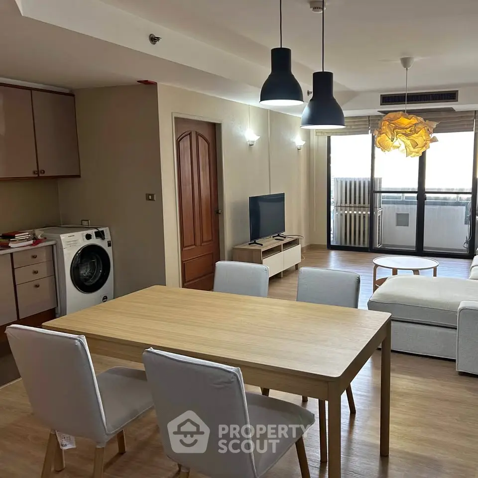 Spacious living room with modern furniture and open layout in a stylish apartment.