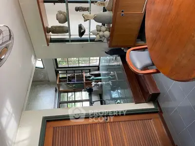 Charming interior with elegant decor and natural light, featuring stylish furniture and artistic elements.