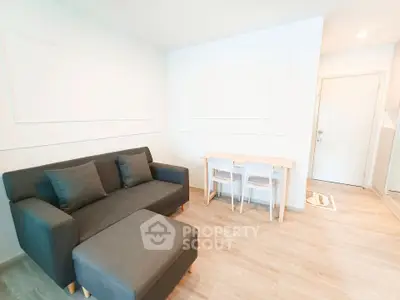 Modern living room with sleek furniture and minimalist decor in a bright apartment.