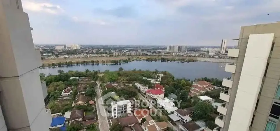 Stunning high-rise view overlooking river and cityscape, perfect for urban living.