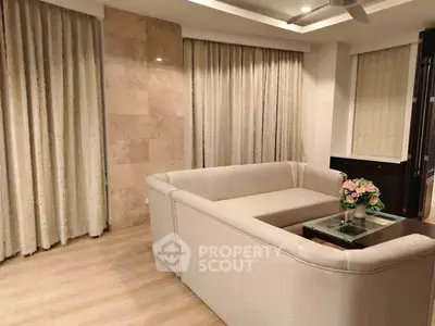 Elegant living room with beige sectional sofa and stylish decor