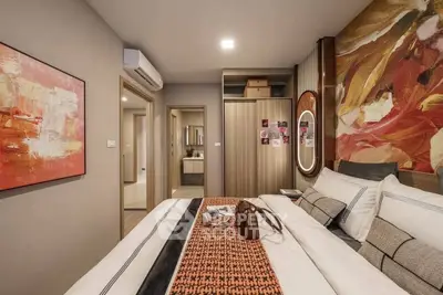 Modern bedroom with stylish decor and cozy ambiance, featuring a large bed and contemporary artwork.