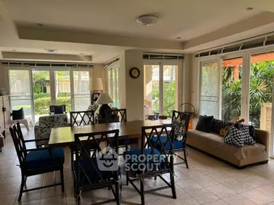 Spacious living room with elegant dining area and garden view, perfect for family gatherings.
