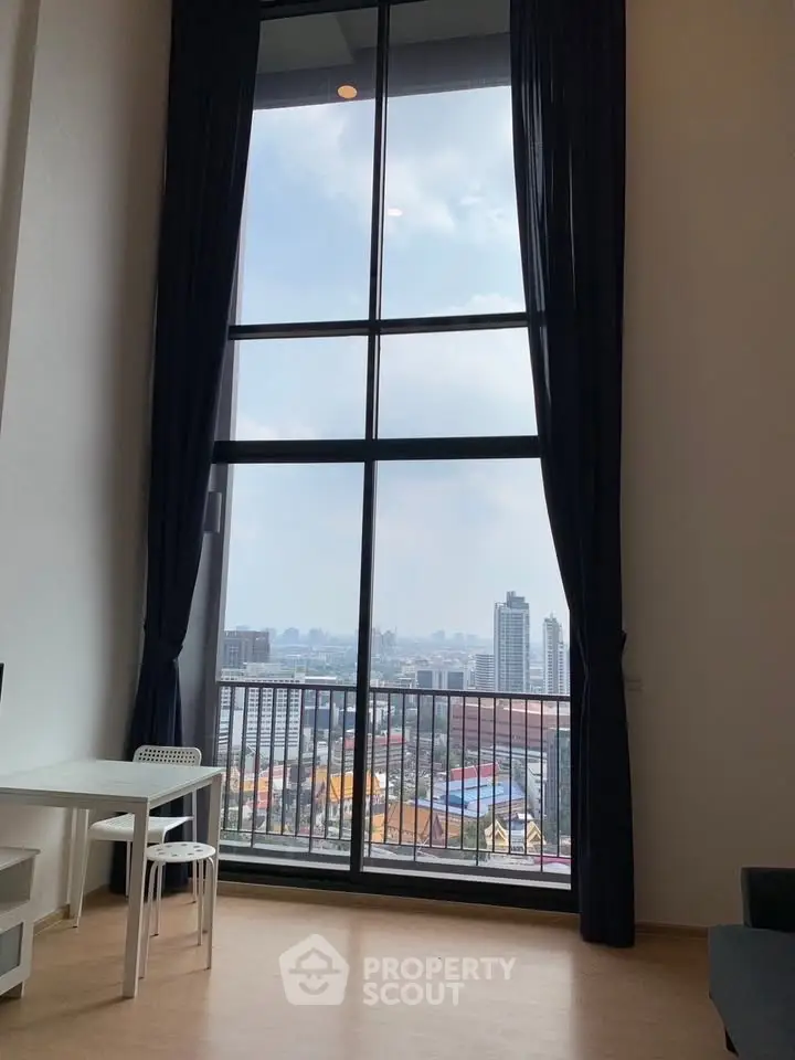 Stunning high-rise apartment with floor-to-ceiling windows offering breathtaking city views.