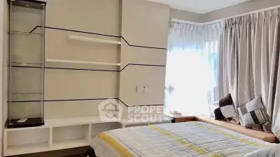 Cozy bedroom with large window and modern shelving unit, perfect for relaxation and comfort.