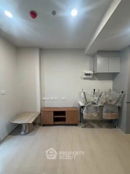 Modern unfurnished room with light wood flooring and minimalistic design.