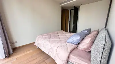 Spacious bedroom with modern decor and cozy bedding in a stylish apartment.