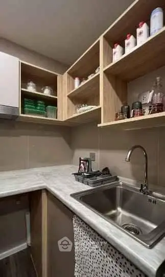 Modern kitchen with sleek countertops and open shelving, perfect for urban living.