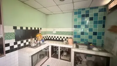 Charming vintage kitchen with colorful tile backsplash and ample counter space.