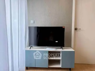 Modern living room with sleek TV stand and flat-screen TV, perfect for cozy entertainment.