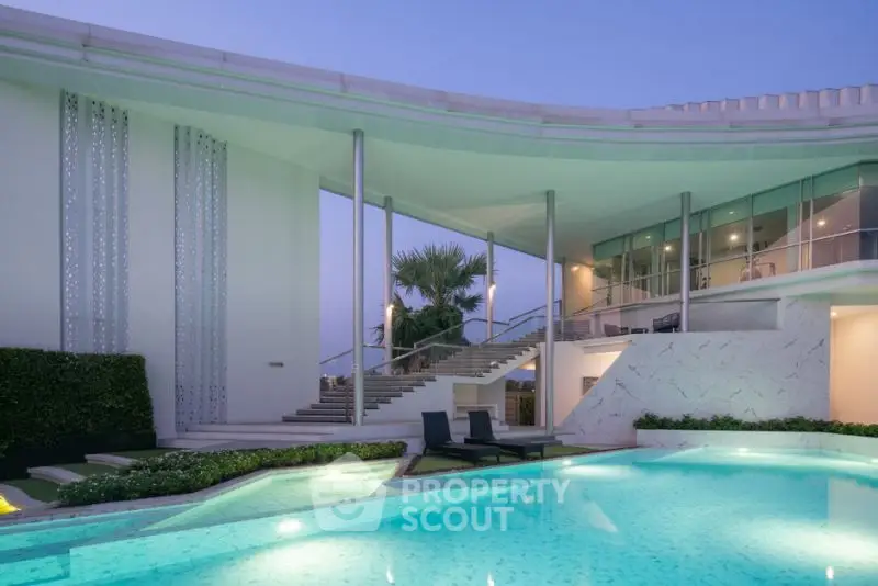 Luxurious modern villa with stunning pool and elegant architecture at dusk.