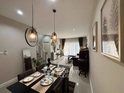 Modern dining and living area with stylish lighting and decor, perfect for entertaining.