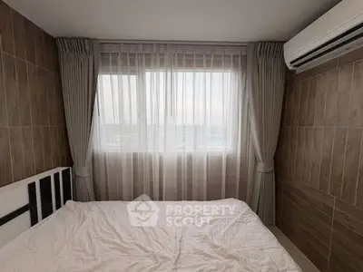 Cozy bedroom with large window and air conditioning unit