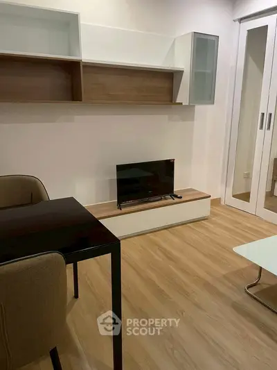 Modern living room with sleek furniture and wooden flooring