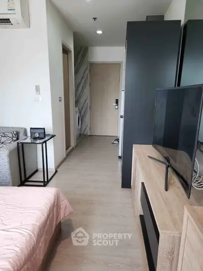 Modern apartment interior with stylish furniture and washing machine in hallway.