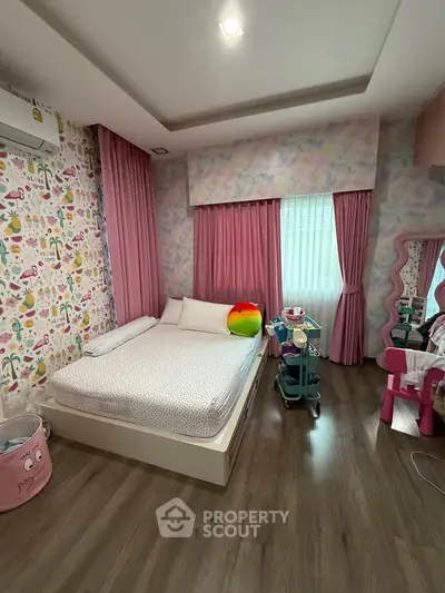 Charming bedroom with colorful decor and cozy ambiance, perfect for a child's playful retreat.