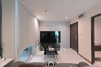 Modern living room with large TV and stylish decor