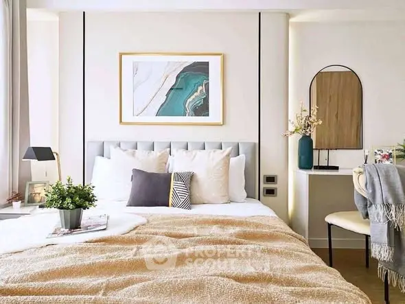 Elegant bedroom with modern decor and cozy ambiance, featuring stylish artwork and plush bedding.