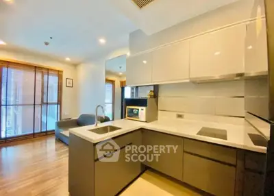 Modern kitchen with sleek cabinetry and open layout in a stylish apartment.