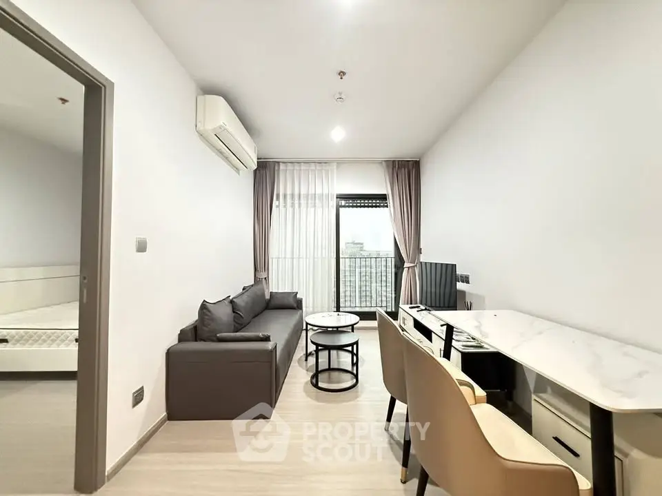 Modern living room with sleek furniture and natural light in a stylish apartment.