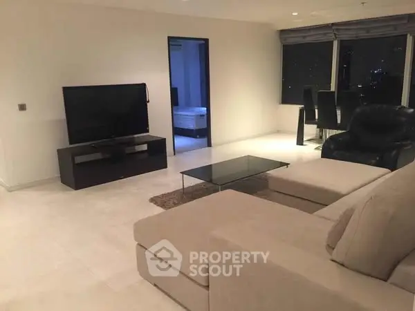 Spacious modern living room with city view and elegant furnishings.