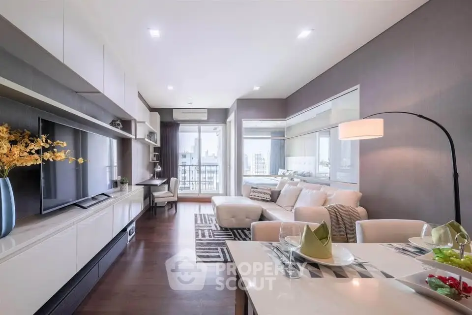 Modern living room with sleek furniture and city view, perfect for urban living.