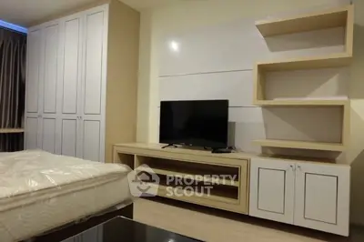 Modern bedroom with built-in wardrobe and TV unit, ideal for urban living.