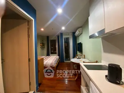 Cozy studio apartment with modern kitchen and wooden flooring