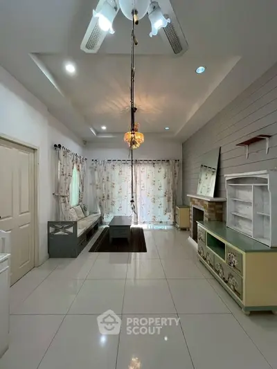 Spacious living room with modern decor and elegant lighting