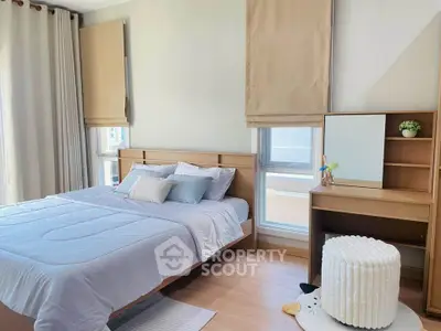 Cozy bedroom with modern furnishings and natural light, perfect for relaxation and comfort.