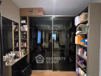 Spacious bedroom with mirrored wardrobe and organized shelving