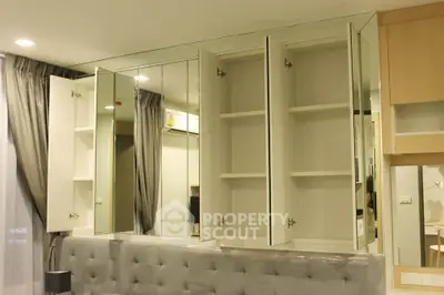 Modern bedroom with mirrored cabinets and elegant gray tufted headboard