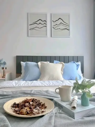 Cozy bedroom with stylish decor, featuring a modern bed, elegant artwork, and a serene ambiance.