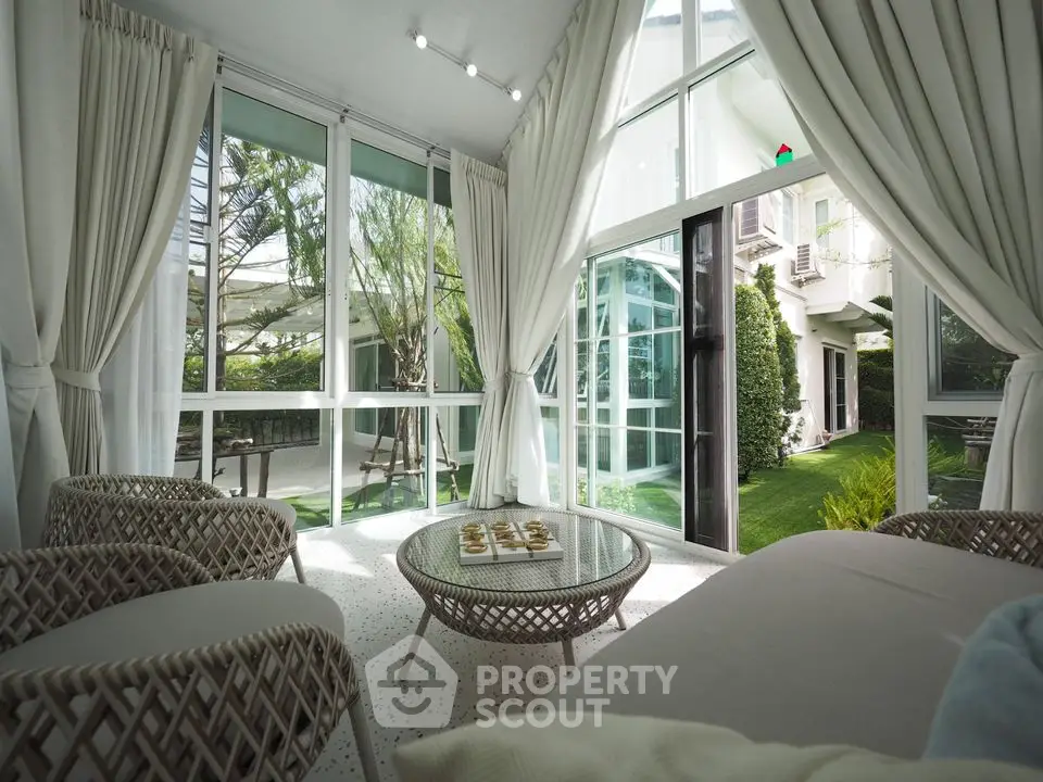 Luxurious sunlit living room with garden view and elegant decor