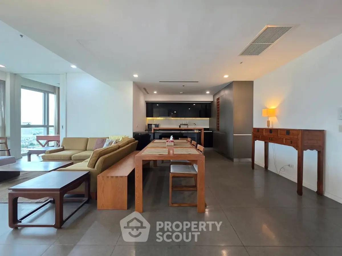 Spacious open-plan living room with modern kitchen and elegant dining area.