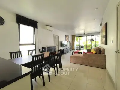 Spacious open-plan living and dining area with modern furnishings and large windows.