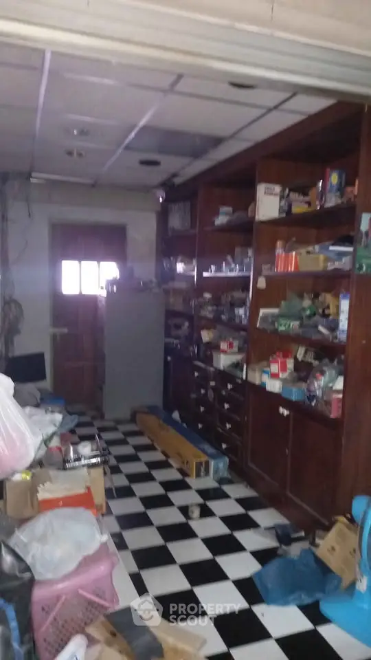 Spacious storage room with checkered floor and wooden shelving