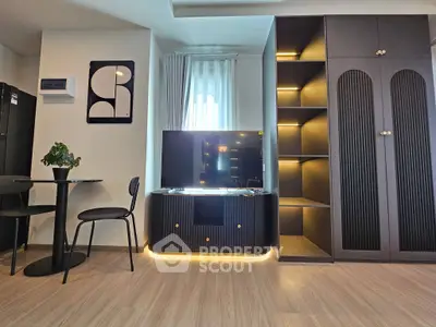 Modern living room with sleek black furniture and ambient lighting