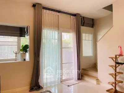 Bright and airy living room with large windows and elegant curtains