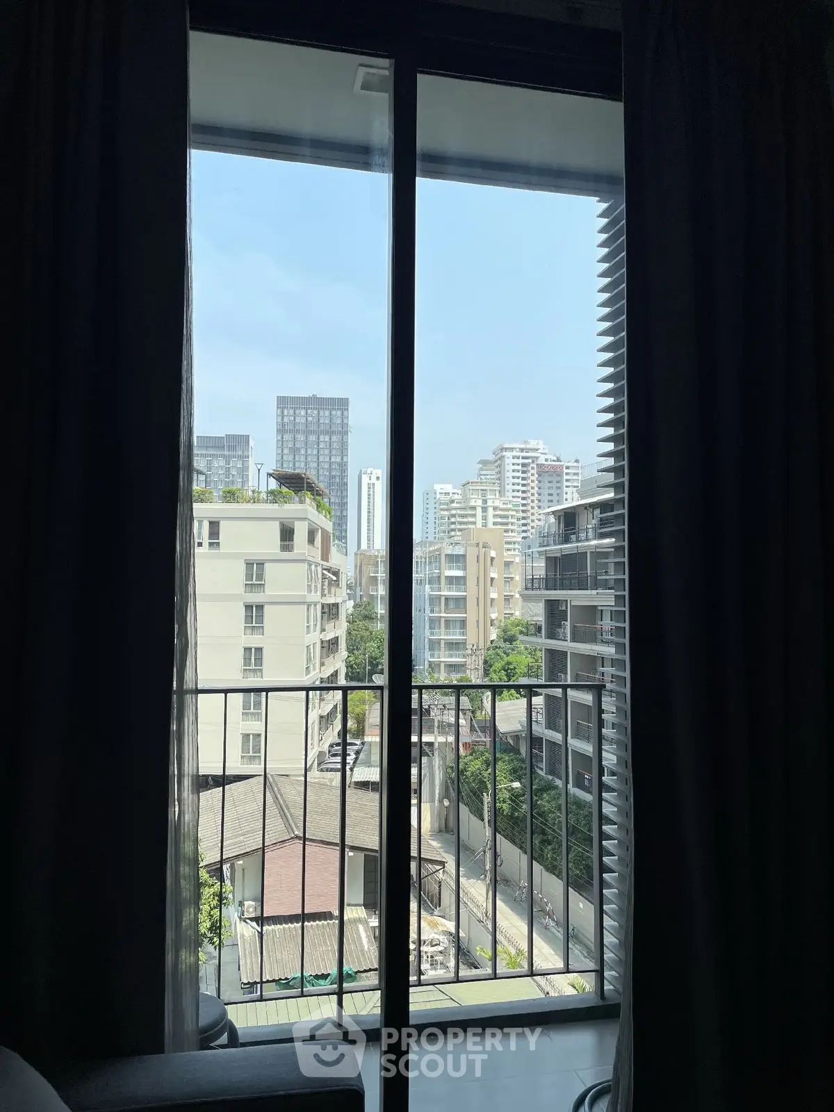 Stunning urban view from a modern apartment balcony with city skyline.