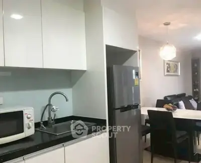 Modern kitchen with sleek cabinetry and dining area in open layout