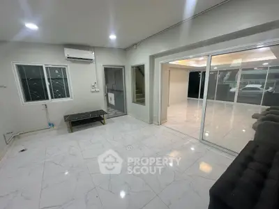 Spacious modern living room with marble flooring and sliding glass doors