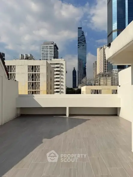 Spacious rooftop terrace with stunning city skyline views, perfect for urban living.